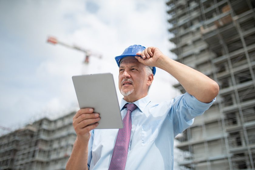 Worker using a construction software programs